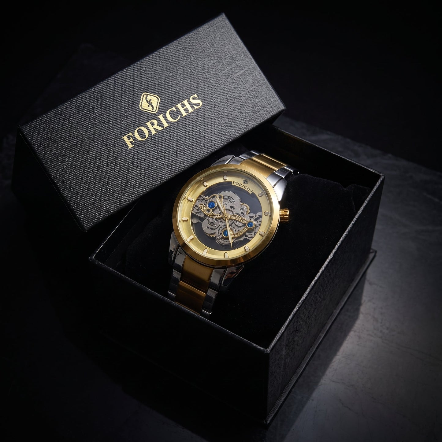 FORICHS two-tone gold automatic skeleton watch with transparent dial and gold bezel, front view
forichs-two-tone-skeleton-watch-07-box.