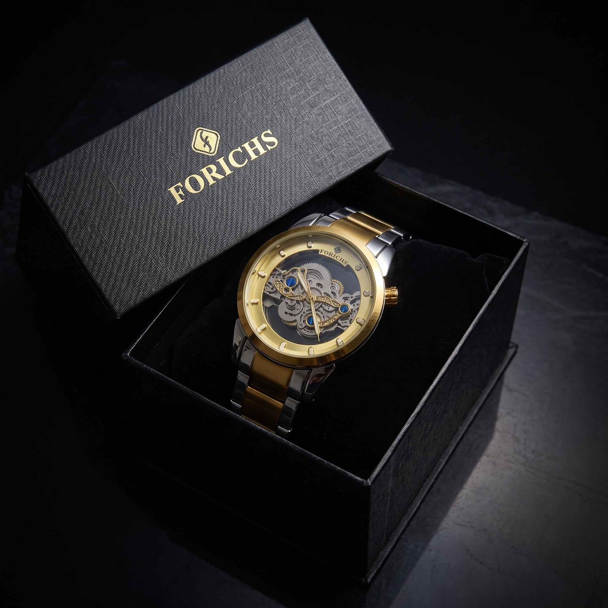 FORICHS two-tone gold automatic skeleton watch with transparent dial and gold bezel, front view
forichs-two-tone-skeleton-watch-07-box.