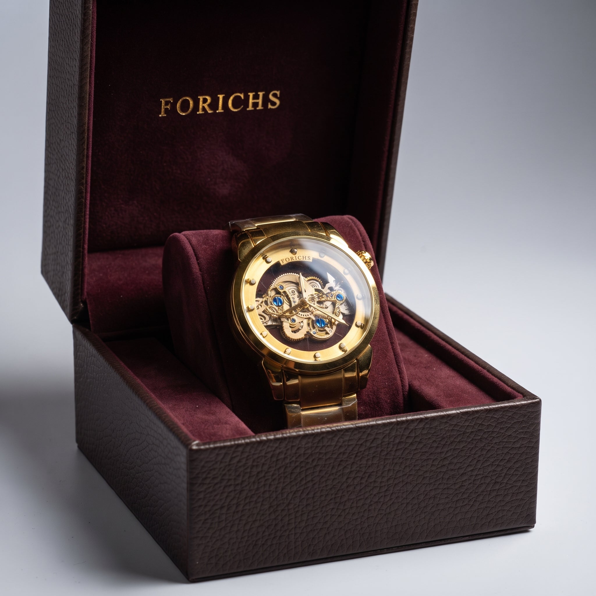 FORICHS full gold automatic skeleton watch displayed in its branded luxury presentation box